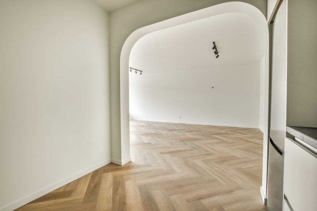 Plastic window and radiator on white wall in empty light room at home
