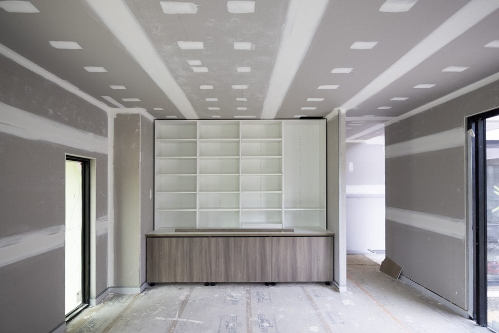 Interior view of an unfinished office and bookcase during a new home build