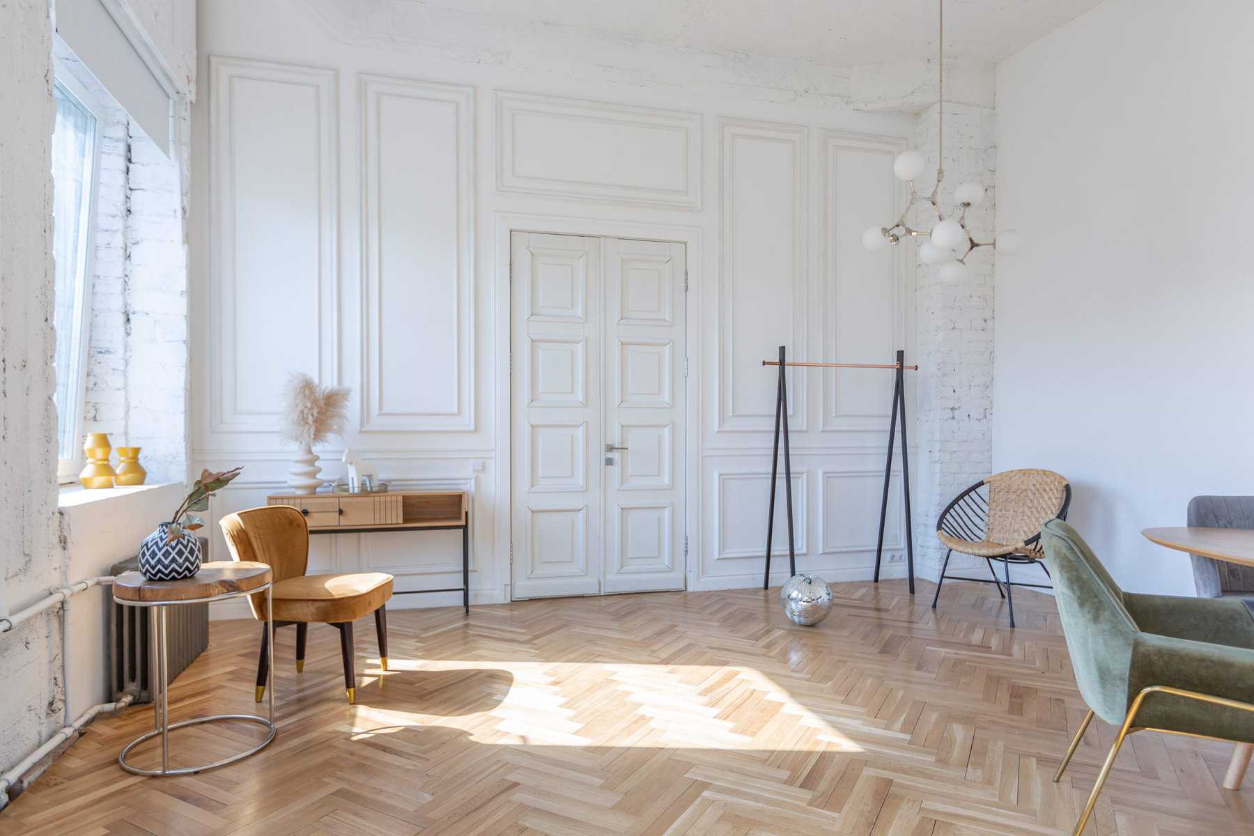 expensive modern light luxury interior design of a spacious living room with wooden elements and white walls. filled with original and unusual decorative things